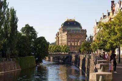 a bridge over a river in front of a building at Luxurious two-bedroom in the Old Town in Prague