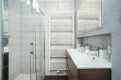 a bathroom with a glass shower and a sink at Luxurious two-bedroom in the Old Town in Prague
