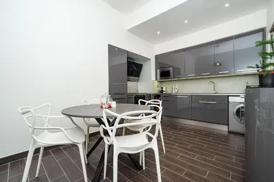 a kitchen with a table and chairs in a room at Luxurious two-bedroom in the Old Town in Prague