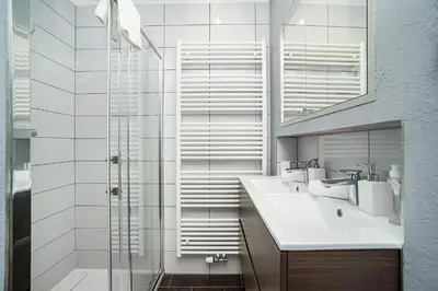 a bathroom with a glass shower and a sink at Luxurious two-bedroom in the Old Town in Prague