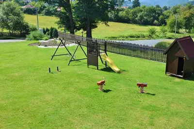 a playground with a slide in a grass field at Penzion Kamejk in Kamýk nad Vltavou