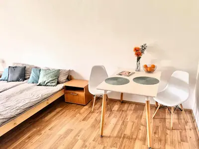 a room with a bed and a table and chairs at Ubytování na venkově Církvice in Zásmuky