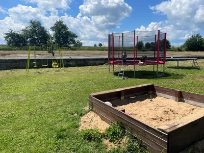 two children playing on a playground in a field at Ubytování na venkově Církvice in Zásmuky