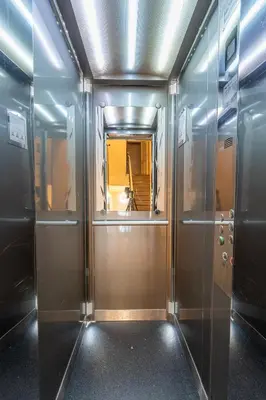 a hallway with metal elevators in a building at Charming Apartment in Spain St in Prague