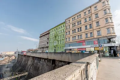 a bridge in the middle of a city with buildings at Charming Apartment in Spain St in Prague