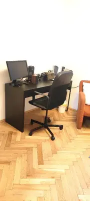an office with a desk with a computer on it at Warm room in the beautiful Smíchov - Prague in Prague