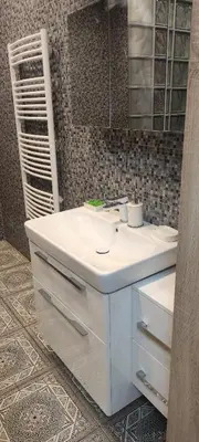 a bathroom with a white sink and a mirror at Warm room in the beautiful Smíchov - Prague in Prague