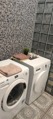 a washer and dryer sitting in a room at Warm room in the beautiful Smíchov - Prague in Prague