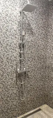a metal towel rack on the wall of a shower at Warm room in the beautiful Smíchov - Prague in Prague