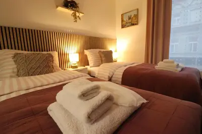 a hotel room with two beds with towels on them at Jasminn Apartments in Prague