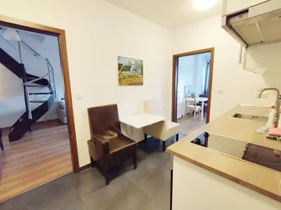 a kitchen with a sink and a table and a table at Cozy rooftop with balcony in Prague