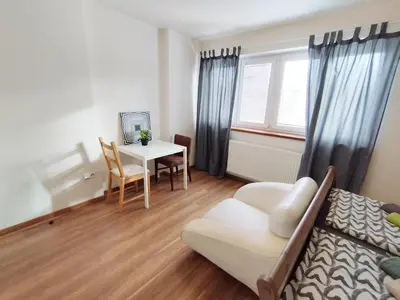 a living room with a couch and a table at Cozy rooftop with balcony in Prague