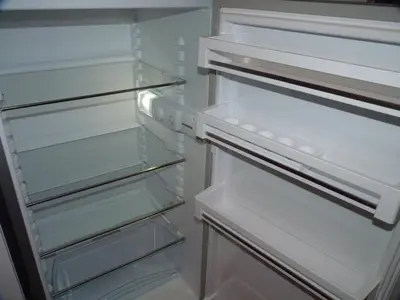 an empty refrigerator with its door open and its shelves at Apartmán Trilobit in Beroun