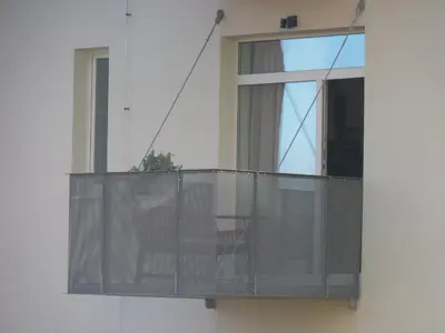 a balcony with a table and a window at Apartmán Trilobit in Beroun