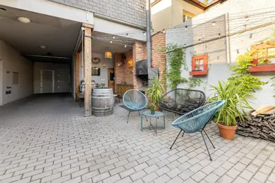 a patio with chairs and a table and a building at Penzion Rodos - Café in Prague