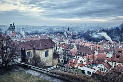 a cityscape of a city with buildings and roofs at Apartment VLTAVA in Prague