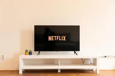 a flat screen tv sitting on top of a white entertainment center at Naru house 6 in Prague