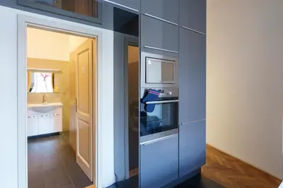 a blue kitchen with a stove and a sink at Naru house 6 in Prague