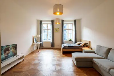 a living room with a couch and a tv at Naru house 6 in Prague