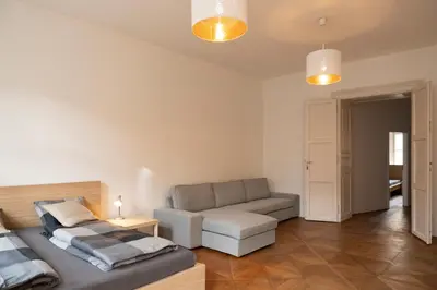 a living room with a bed and a couch at Naru house 6 in Prague