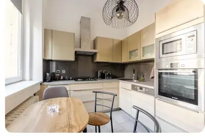 a kitchen with a wooden table and a dining room at Apartmán l Praha centrum in Prague