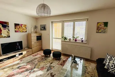 a living room with a television and two stools at Harrison Homes Prague Apartment 01 Terrace and Parking in Prague