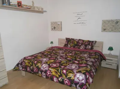 a bedroom with a bed with a colorful blanket at Harrison Homes Prague Apartment 01 Terrace and Parking in Prague