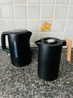 two black coffee pots sitting on a kitchen counter at Harrison Homes Prague Apartment 01 Terrace and Parking in Prague