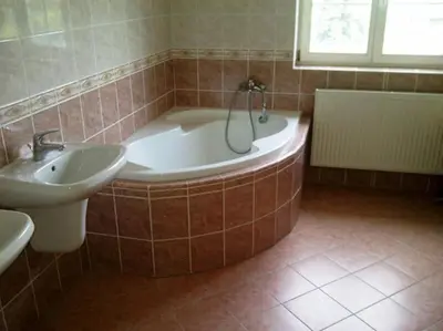 a bathroom with a bath tub and a sink at Harrison Homes Prague Apartment 01 Terrace and Parking in Prague