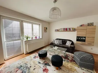 a living room with a couch and a glass table at Harrison Homes Prague Apartment 01 Terrace and Parking in Prague