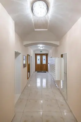 an empty hallway with a ceiling with a chandelier at Central Haven Apartments in Prague