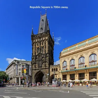 a building with a clock tower in a city at Central Haven Apartments in Prague