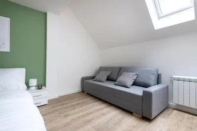 a living room with a couch and a bed at Central Haven Apartments in Prague