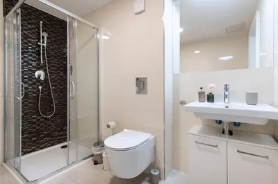 a bathroom with a shower and a toilet and a sink at Central Haven Apartments in Prague