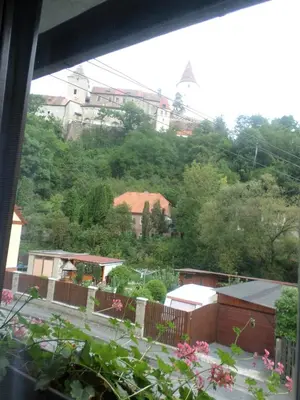 a view from a window of a town with a hill at Penzion v Budech in Křivoklát