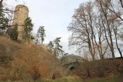 a water tower and a bridge on a hill with trees at Penzion v Budech in Křivoklát