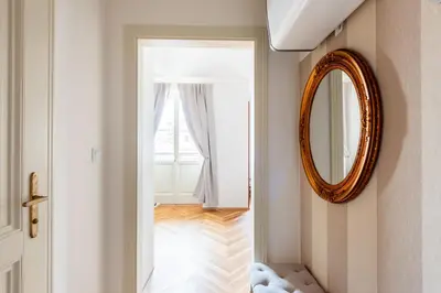 a hallway with a mirror and a window at Little Chateau in Prague