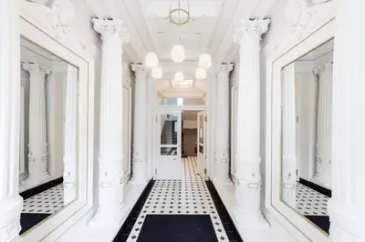 a hallway with white columns and a ceiling at Little Chateau in Prague