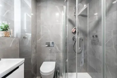 a bathroom with a shower with a toilet and a sink at Little Chateau in Prague