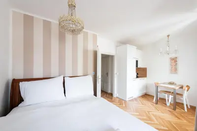 a bedroom with a bed and a striped wall at Little Chateau in Prague