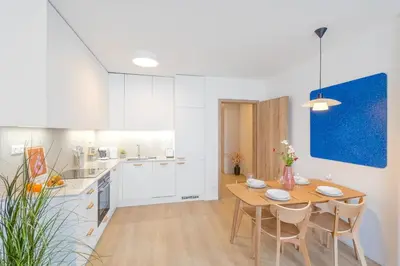 a kitchen and dining room with a table and chairs at Design Apartment - Balcony, Free Parking, Yoga, 10 mins to center, by Gravity Prague in Prague