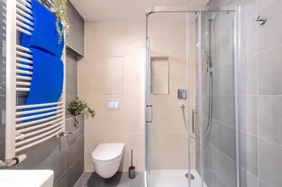 a bathroom with a shower and a toilet at Design Apartment - Balcony, Free Parking, Yoga, 10 mins to center, by Gravity Prague in Prague