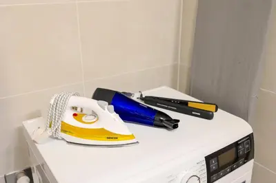 a hair dryer and a pen sitting on top of a appliance at Design Apartment - Balcony, Free Parking, Yoga, 10 mins to center, by Gravity Prague in Prague