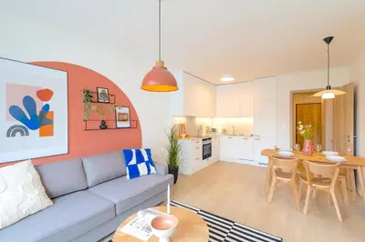 a living room with a couch and a table at Design Apartment - Balcony, Free Parking, Yoga, 10 mins to center, by Gravity Prague in Prague