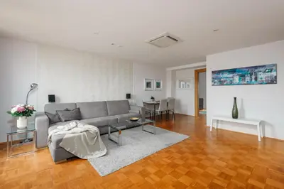 a living room with a couch and a table at ROY 2 bdr Apartment with Prague Castle View, Parking & AC in Prague