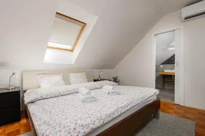 a bedroom with a bed with two towels on it at ROY 2 bdr Apartment with Prague Castle View, Parking & AC in Prague