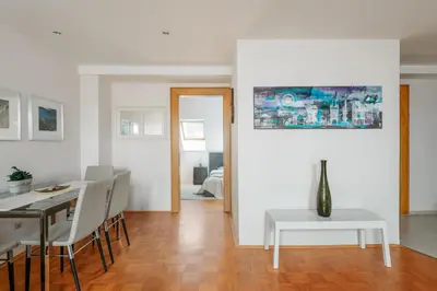 a dining room and living room with a table and chairs at ROY 2 bdr Apartment with Prague Castle View, Parking & AC in Prague