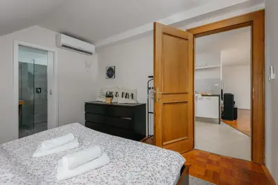a bedroom with a bed with two white towels on it at ROY 2 bdr Apartment with Prague Castle View, Parking & AC in Prague