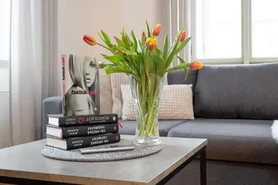 a vase on a table with a stack of books at U Zlaté hvězdy Kalich in Litoměřice