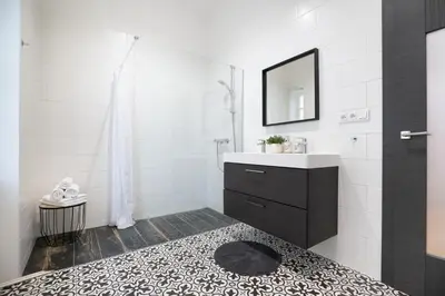 a white bathroom with a sink and a mirror at U Zlaté hvězdy Kalich in Litoměřice